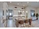 Modern kitchen featuring an island with seating and pendant lights, stainless appliances, and white cabinets at 6091 N Sunrise Ln, Buckeye, AZ 85396