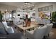 Open-concept living area featuring a modern kitchen, dining space, and comfortable seating with stylish décor at 6091 N Sunrise Ln, Buckeye, AZ 85396
