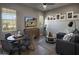 Cozy living area with round table, TV, modern decor, and natural light from two windows at 6091 N Sunrise Ln, Buckeye, AZ 85396
