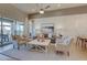 Bright living room featuring modern decor, white wainscoting, and sliding glass doors to the backyard at 6091 N Sunrise Ln, Buckeye, AZ 85396