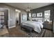 Elegant bedroom showcasing a full bathroom, chandelier, and hardwood floors at 6091 N Sunrise Ln, Buckeye, AZ 85396