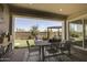 Outdoor dining space on covered patio with stylish dining table and chairs overlooking backyard at 6091 N Sunrise Ln, Buckeye, AZ 85396