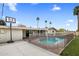 Backyard swimming pool area with basketball hoop and grassy lawn at 6912 N 19Th St, Phoenix, AZ 85016