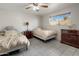 Bright bedroom featuring two twin beds, tiled flooring, and a well-lit window with a view of the outdoors at 6912 N 19Th St, Phoenix, AZ 85016