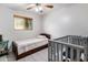 Charming bedroom featuring a twin bed, crib, tiled flooring, and window view, ideal for a Bedroom setup at 6912 N 19Th St, Phoenix, AZ 85016