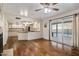 Inviting living room featuring wood floors, a ceiling fan, and a sliding door to the outdoor pool area at 6912 N 19Th St, Phoenix, AZ 85016