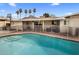 Backyard pool with palm trees and -proof barrier on a sunny day at 6912 N 19Th St, Phoenix, AZ 85016