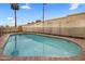Clean swimming pool enclosed by a fence and surrounded by a concrete wall at 6912 N 19Th St, Phoenix, AZ 85016