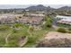 Community with lush green spaces and walking trails nestled below mountains and buildings with tile roofs at 7275 N Scottsdale Rd # 1001, Paradise Valley, AZ 85253