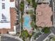 Aerial view of the community pool, lush landscaping, and tiled rooftops at 7275 N Scottsdale Rd # 1001, Paradise Valley, AZ 85253