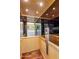 An interior view of the residential elevator with hardwood floor, wooden paneled walls, and mirrored ceiling at 7275 N Scottsdale Rd # 1001, Paradise Valley, AZ 85253