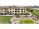 Attractive condo building with lush greenery, a walkway, and mature shade trees at 7275 N Scottsdale Rd # 1001, Paradise Valley, AZ 85253
