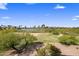 Aerial view showcasing the lush green golf course and distant mountain views at 7275 N Scottsdale Rd # 1001, Paradise Valley, AZ 85253