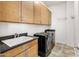 Well-equipped laundry room with modern washer, dryer and cabinets at 7275 N Scottsdale Rd # 1001, Paradise Valley, AZ 85253