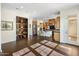 Open-concept living area flowing into an eat-in kitchen, dark wood floors and plenty of natural light at 7275 N Scottsdale Rd # 1001, Paradise Valley, AZ 85253