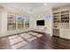 Bright living room with large windows, a flat-screen TV, built-in shelving, and a wine cooler at 7275 N Scottsdale Rd # 1001, Paradise Valley, AZ 85253