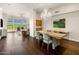 Bright open-concept living room with dining area, hardwood floors, large windows and chandelier at 7275 N Scottsdale Rd # 1001, Paradise Valley, AZ 85253
