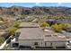 Bird's-eye view of a home with an extended patio, desert landscaping, and mountain views at 8817 S 18Th Way, Phoenix, AZ 85042