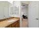 This well-lit bathroom features modern fixtures and a granite countertop with wooden cabinets at 8817 S 18Th Way, Phoenix, AZ 85042