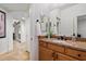 Bathroom featuring a decorative mirror and granite countertops above wood cabinets at 8817 S 18Th Way, Phoenix, AZ 85042