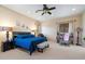 Spacious bedroom with a king bed, ceiling fan, and natural light at 8817 S 18Th Way, Phoenix, AZ 85042
