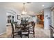Bright dining area with a decorative chandelier and an open floorplan to the kitchen and living areas at 8817 S 18Th Way, Phoenix, AZ 85042