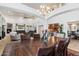 Open concept dining and living room featuring a fireplace, chandelier, and spacious design at 8817 S 18Th Way, Phoenix, AZ 85042