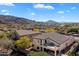 Aerial view of a beautiful home with a balcony, covered patio, manicured landscaping, and mountain views at 8817 S 18Th Way, Phoenix, AZ 85042