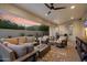 Outdoor patio with comfortable seating, fire pit, and a ceiling fan at 8817 S 18Th Way, Phoenix, AZ 85042