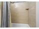 Shower showcasing neutral tiling and a built-in shelf at 8817 S 18Th Way, Phoenix, AZ 85042