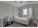Bright bedroom with a four-poster bed, workspace, and a neutral color palette at 9509 W Tonopah Dr, Peoria, AZ 85382