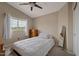 Bright bedroom featuring vaulted ceiling, fan, and natural light from the large window at 9509 W Tonopah Dr, Peoria, AZ 85382