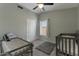 Bedroom with dual beds, carpet floors, ceiling fan, and closet at 9509 W Tonopah Dr, Peoria, AZ 85382