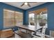 Cozy dining room with a wooden table and a bright window overlooking the backyard at 9509 W Tonopah Dr, Peoria, AZ 85382
