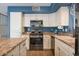 Updated kitchen with white cabinetry, stainless steel appliances, and granite countertops at 9509 W Tonopah Dr, Peoria, AZ 85382