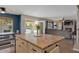 Kitchen with granite countertop island overlooking living area and views of backyard pool at 9509 W Tonopah Dr, Peoria, AZ 85382