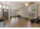 A spacious living room featuring wood floors, large windows, and an arched entry door at 9509 W Tonopah Dr, Peoria, AZ 85382