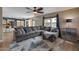 Spacious living room with a comfortable sectional, rug, and seamless flow to the kitchen at 9509 W Tonopah Dr, Peoria, AZ 85382