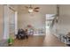 A spacious living room featuring wood floors, and an arched entry door leading to staircase at 9509 W Tonopah Dr, Peoria, AZ 85382
