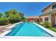 Relaxing backyard pool featuring tiled accents, surrounded by lush greenery and a private outdoor setting at 9509 W Tonopah Dr, Peoria, AZ 85382