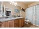 Bathroom featuring double sinks with wood cabinets, granite countertops, and a shower with bathtub at 9722 W Prospector Dr, Queen Creek, AZ 85144