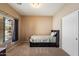 Simple bedroom with a daybed, carpet flooring, large window, and closet at 9722 W Prospector Dr, Queen Creek, AZ 85144