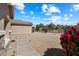Charming front yard with desert landscaping, colorful bougainvillea, and mountain views at 9722 W Prospector Dr, Queen Creek, AZ 85144