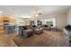 Open living room with a comfortable sectional sofa and large windows overlooking the yard at 9722 W Prospector Dr, Queen Creek, AZ 85144