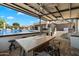 Outdoor kitchen and dining area, complete with a built-in grill and bar seating by the pool at 9722 W Prospector Dr, Queen Creek, AZ 85144