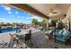 Beautiful patio with comfortable seating, a dining table, and a view of the pool at 9722 W Prospector Dr, Queen Creek, AZ 85144