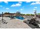 Resort style pool and spa featuring poolside lounge chairs and covered patios at 9722 W Prospector Dr, Queen Creek, AZ 85144