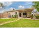 Expansive backyard with a covered patio, lush lawn, and easy access from inside at 9834 E Fairview Ave, Mesa, AZ 85208