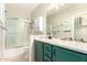A beautifully decorated bathroom with a shower, granite counters, and plenty of cabinet space at 9834 E Fairview Ave, Mesa, AZ 85208