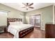 A large bedroom features a ceiling fan, wood floors, and sliding doors to a patio at 9834 E Fairview Ave, Mesa, AZ 85208